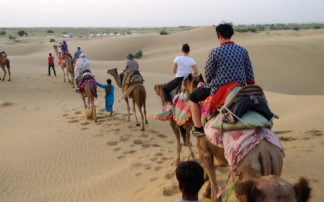 Riding camels in the desert of Jaisalmer, India